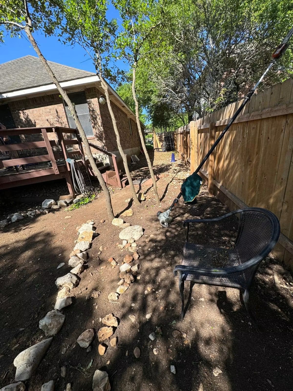 Residential side yard before compacted-path and river-rock installation