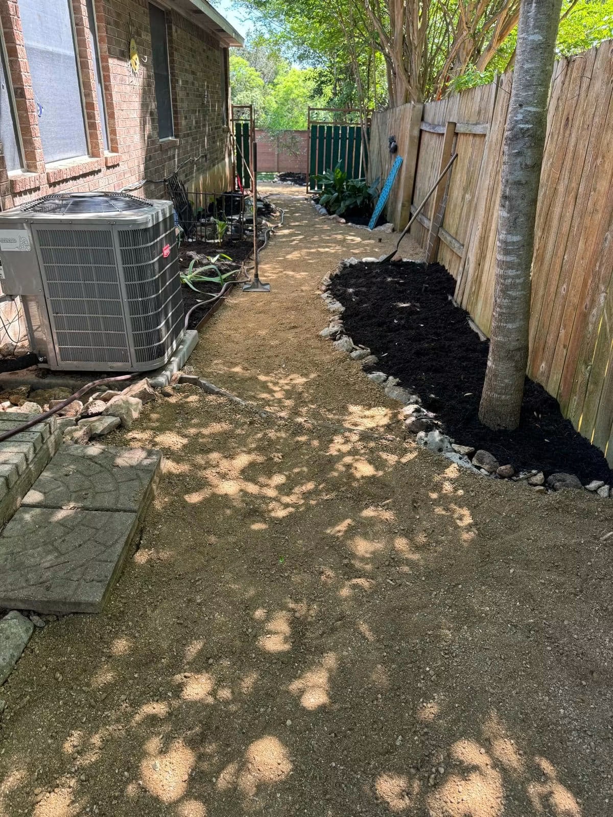 Side yard after overgrowth clearing, cleanup, and gravel-path installation